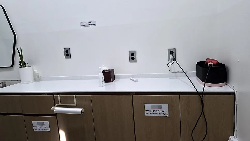 Spin dryer for swimsuits in the shower room next to the pool