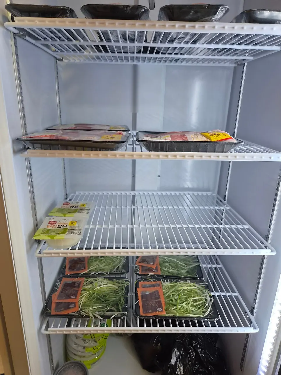 Store shelves stocked with ramyeon, snacks and drinks