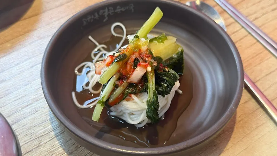 Basic side dishes of yeolmu kimchi and thin noodles