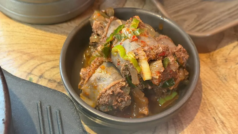 A bowl packed with sausage and meat