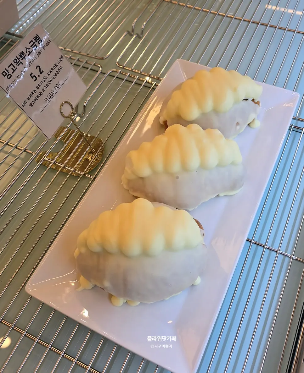 Orange marmalade bread and mango wakppu salt bread in the display case