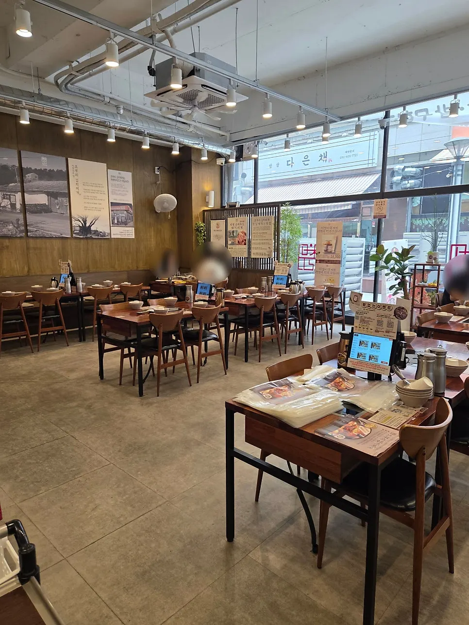 Restaurant interior with floor-to-ceiling windows and high ceiling