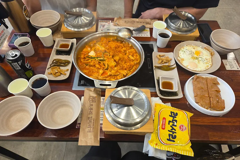 A full table spread with kimchi jjigae and side dishes