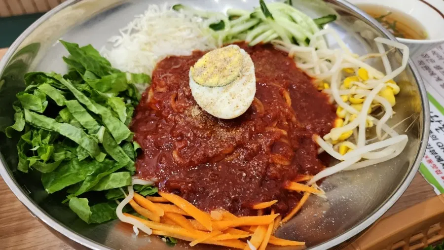 Spicy jjolmyeon served with plastic gloves