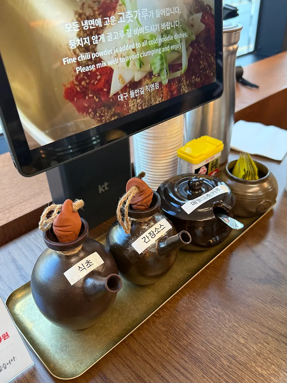 Self-serve bar with hot broth and kimchi