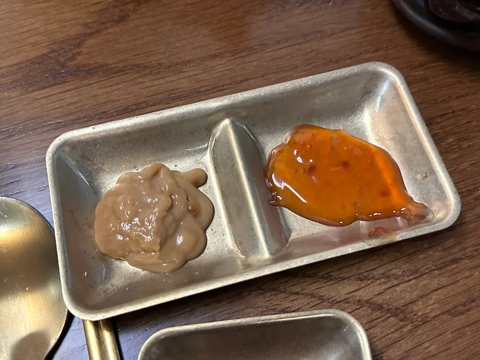 Peanut sauce and chili sauce brought from the self-serve bar