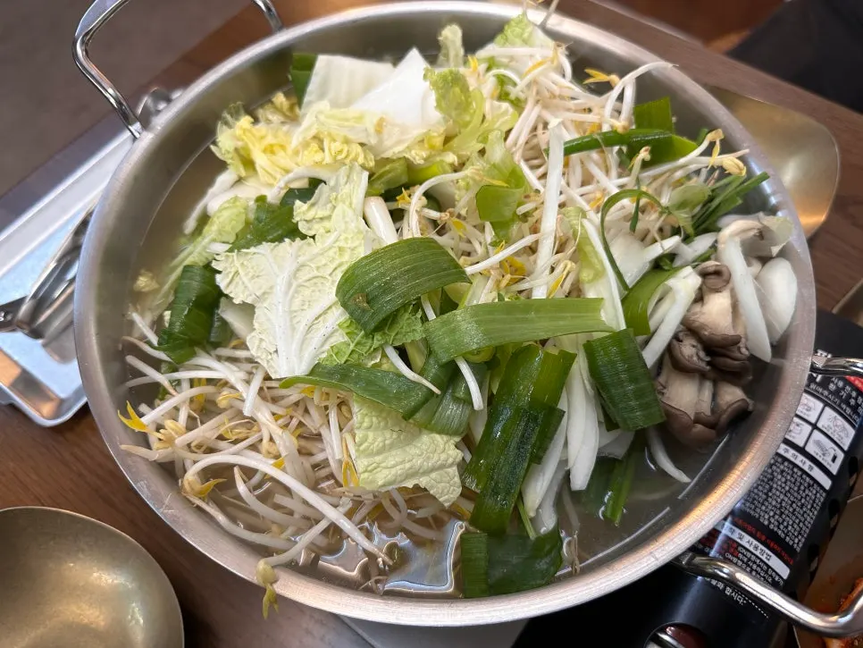Pot of dak hanmari filled with vegetables and mushrooms