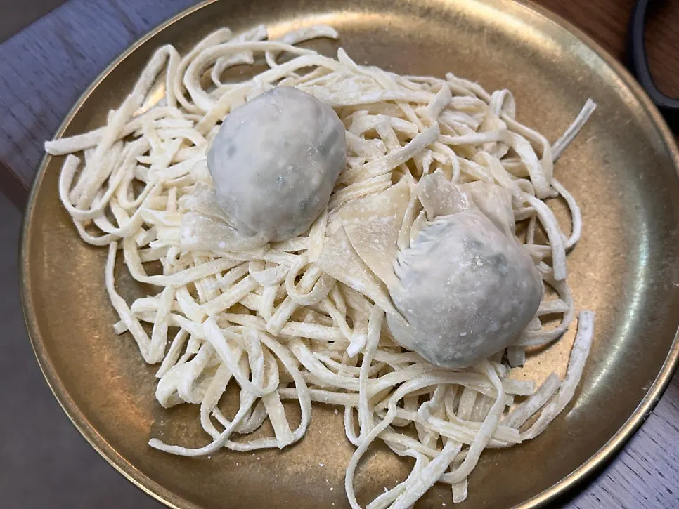 Pot with the set's kalguksu noodles and dumplings added