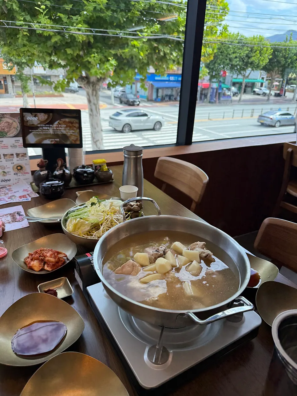 Clear broth being poured into the dak hanmari pot