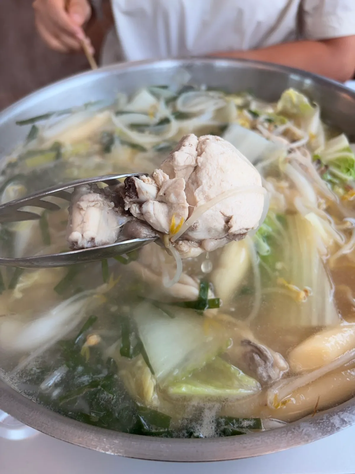 Hourglass timing the chicken as the broth boils