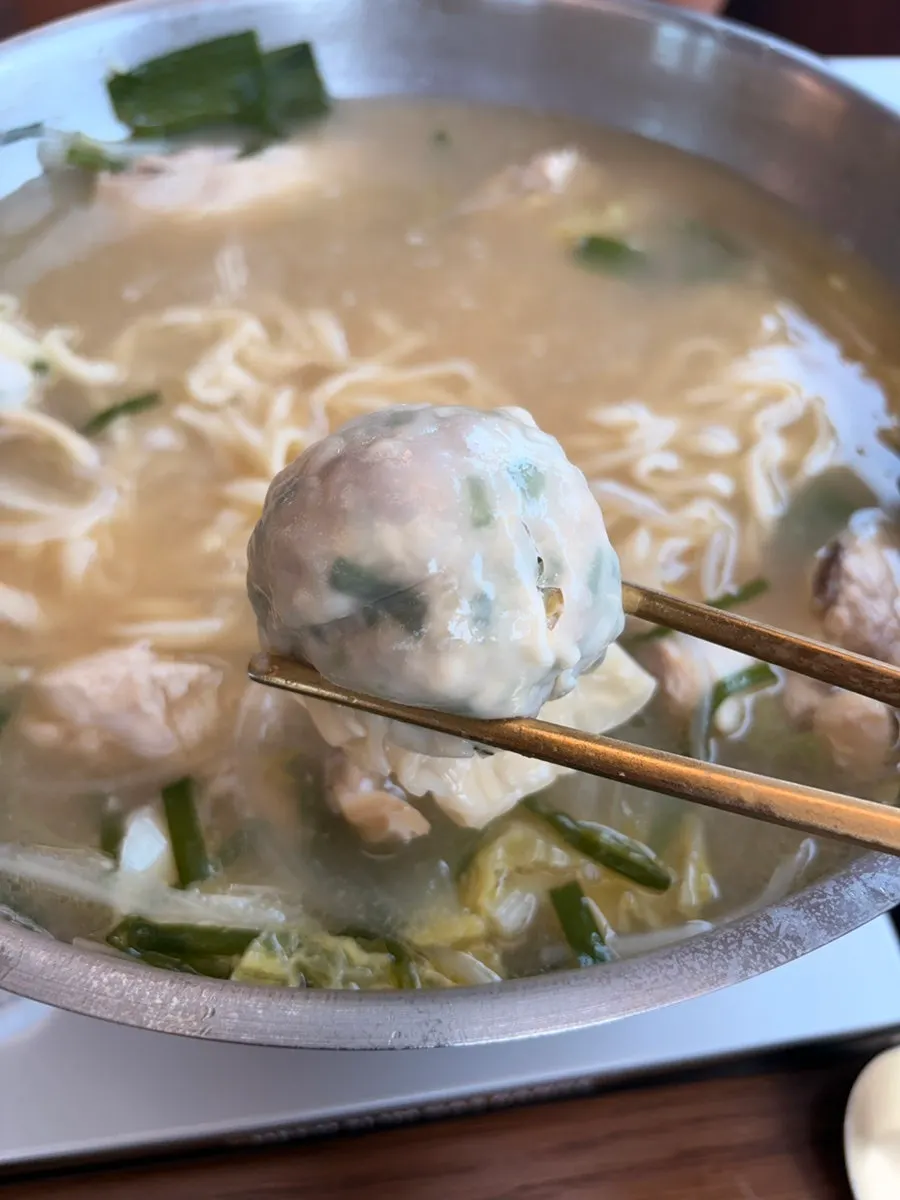 Kalguksu noodles and dumplings simmering in rich broth