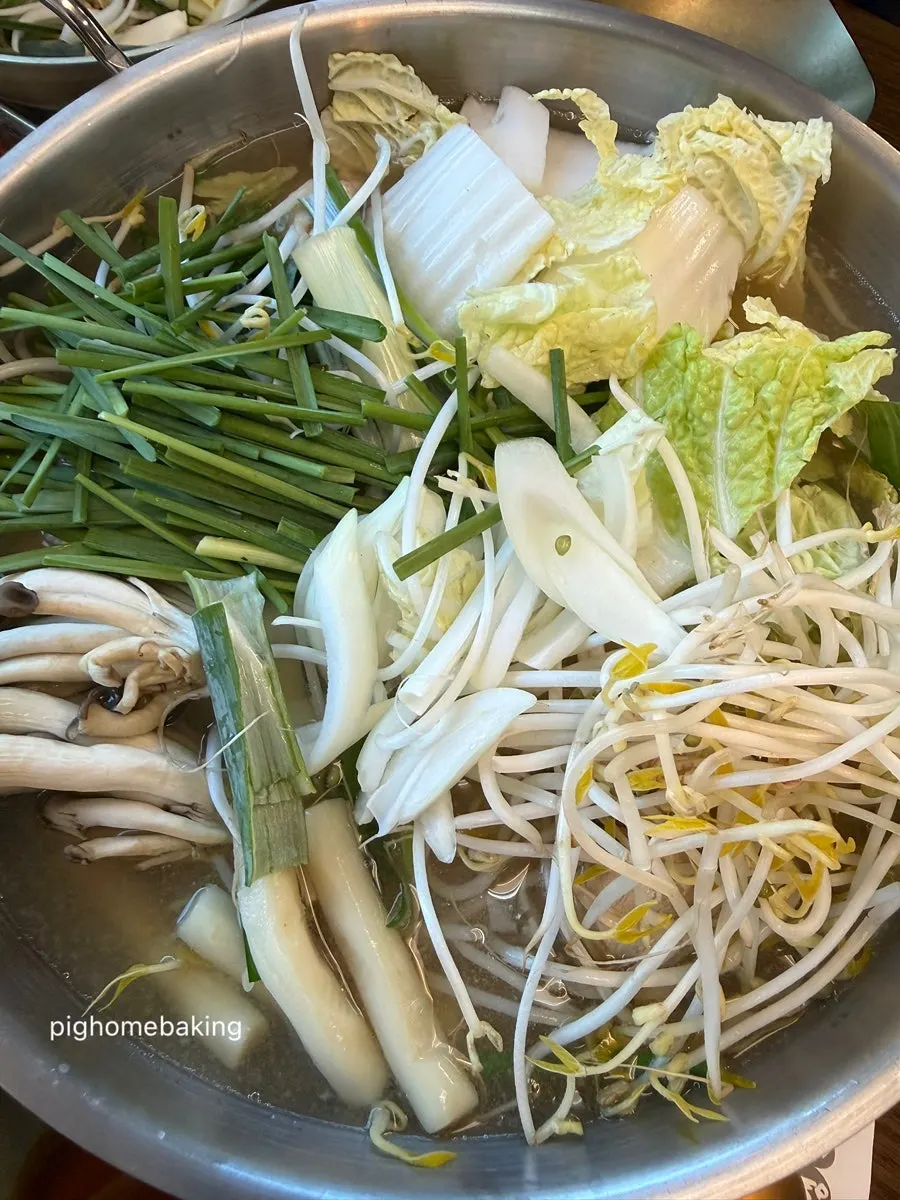 Vegetable bowl with napa cabbage, chives, mushrooms, bean sprouts, and rice cake