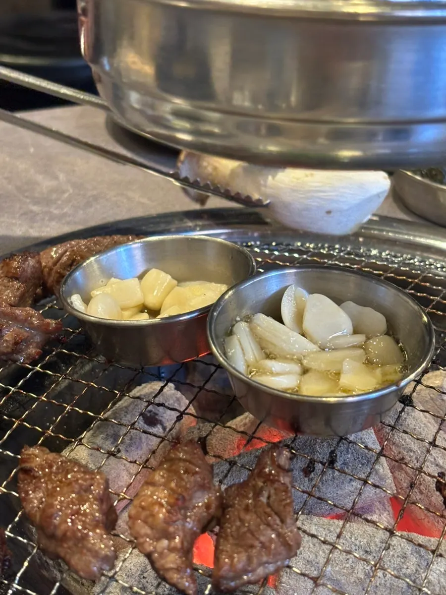 Garlic grilling alongside galbisal on the pan