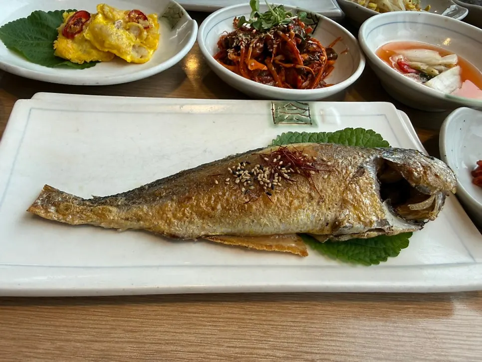 Full spread of the dried corvina set with 12 side dishes