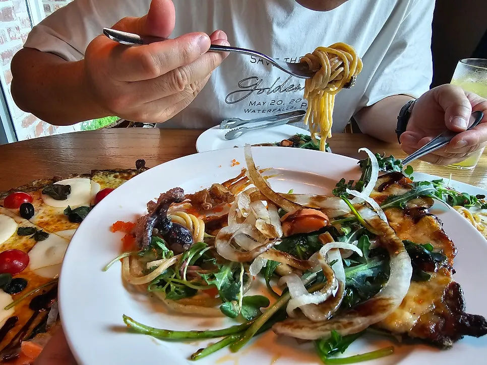 Slice of rocket smoked salmon pizza