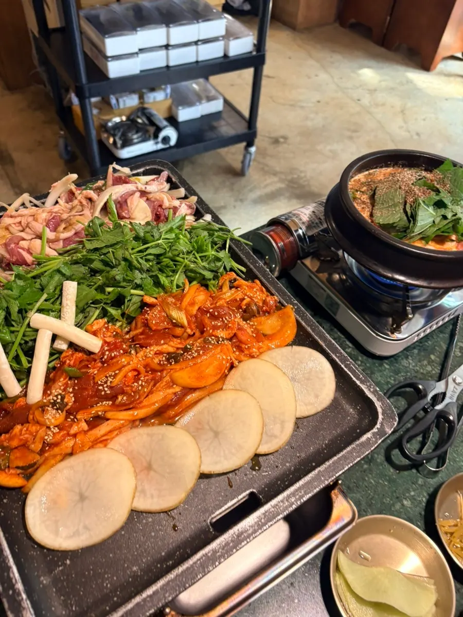Minari placed on the grill alongside duck