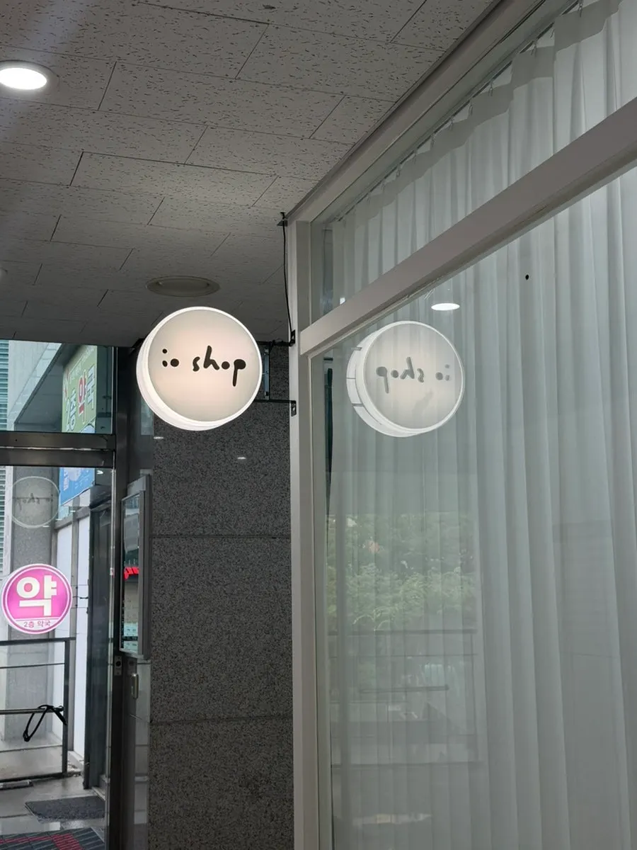 Curtained entrance to Iyo Shop with the "io shop" sign