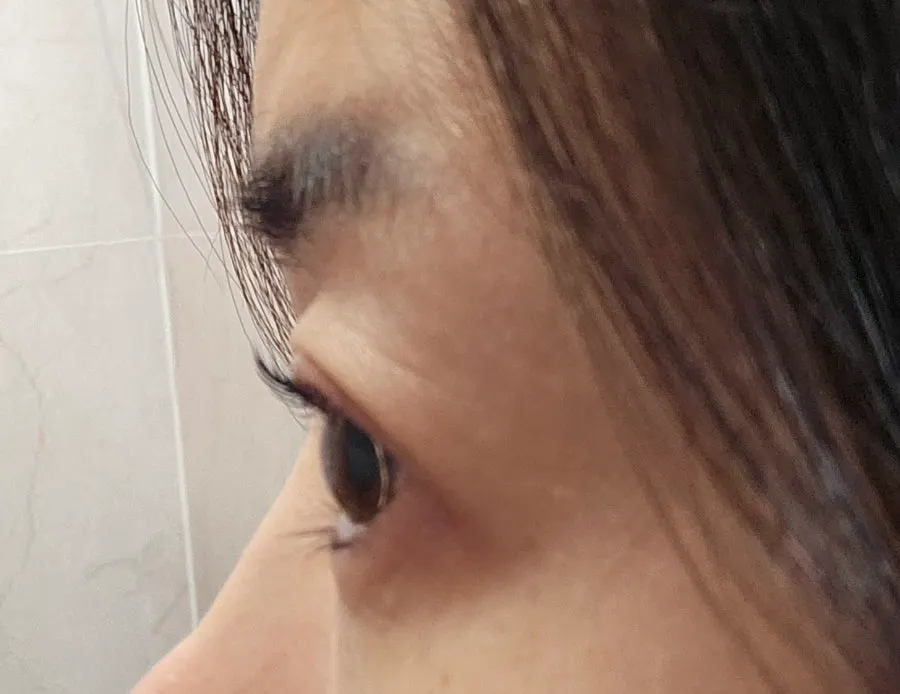 Close-up of dark-looking black-tinted lashes without mascara