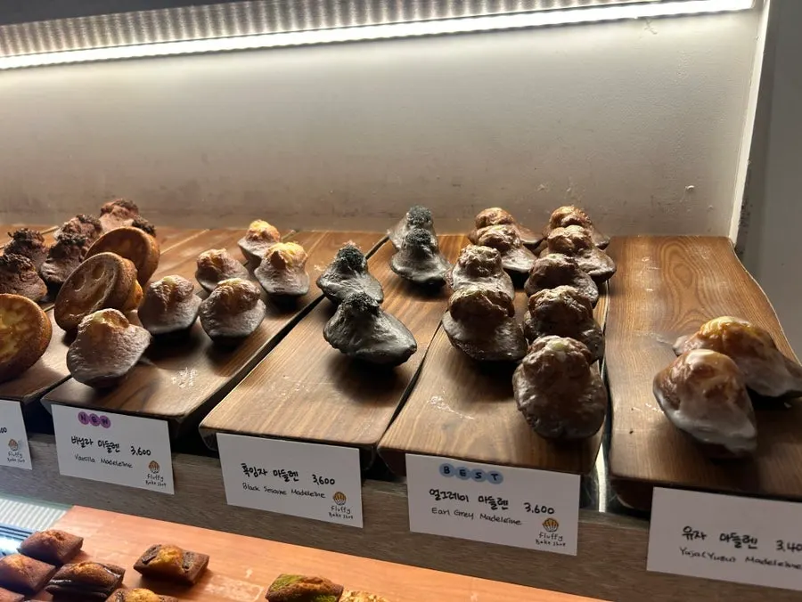 Black sesame madeleine coated in glaze