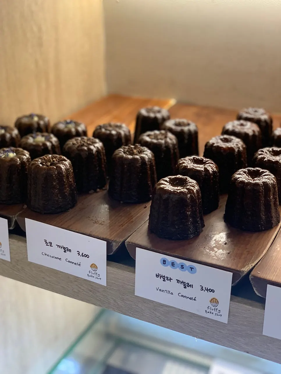 Canelés and financiers laid out in the display case