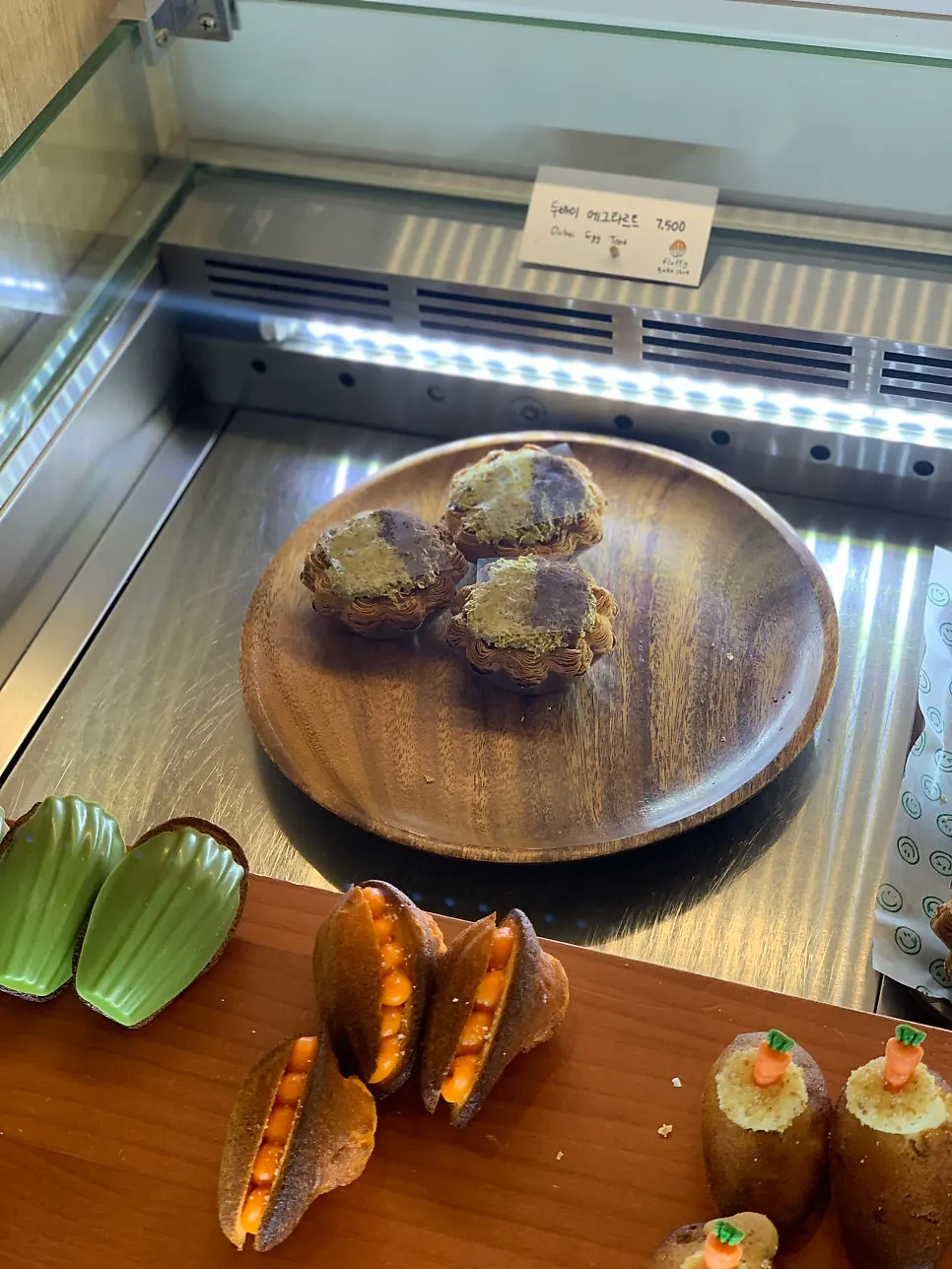 Customer picking out desserts in front of the display case