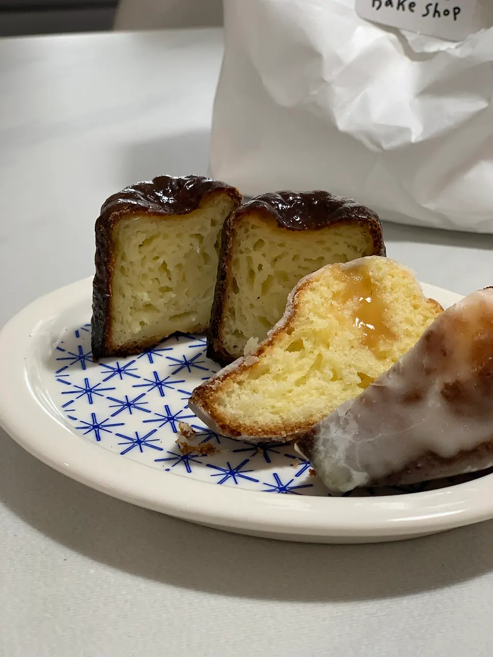 Plain canelé cut in half with a knife