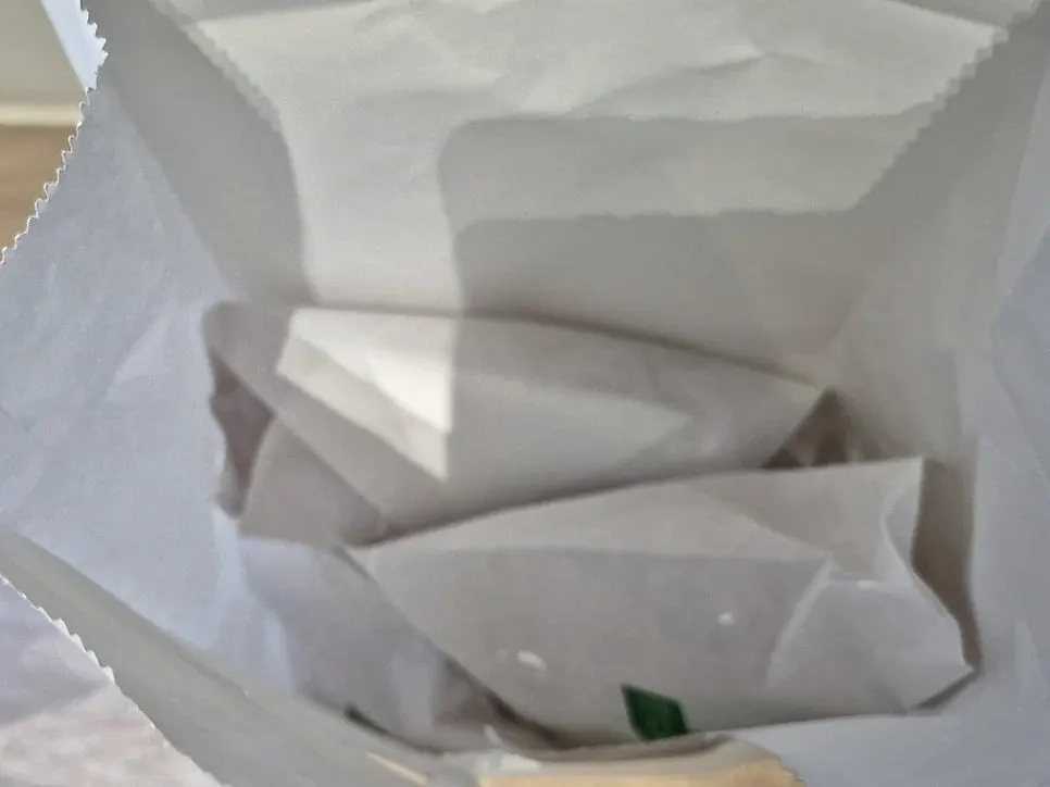 Takeout bag of packaged pastries