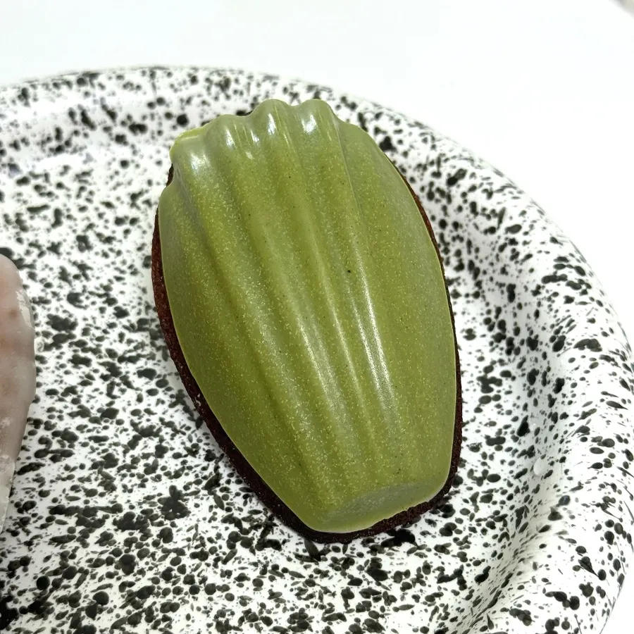 Chocolate-coated matcha madeleine