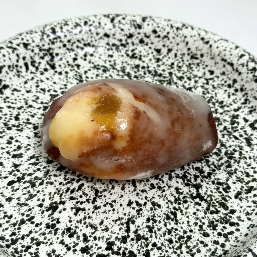 Yuzu madeleine coated in yuzu glaze