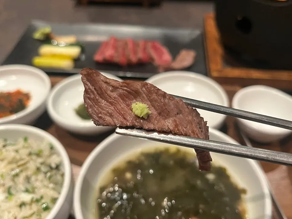 Hanwoo sirloin grilled medium-rare on a mini charcoal brazier