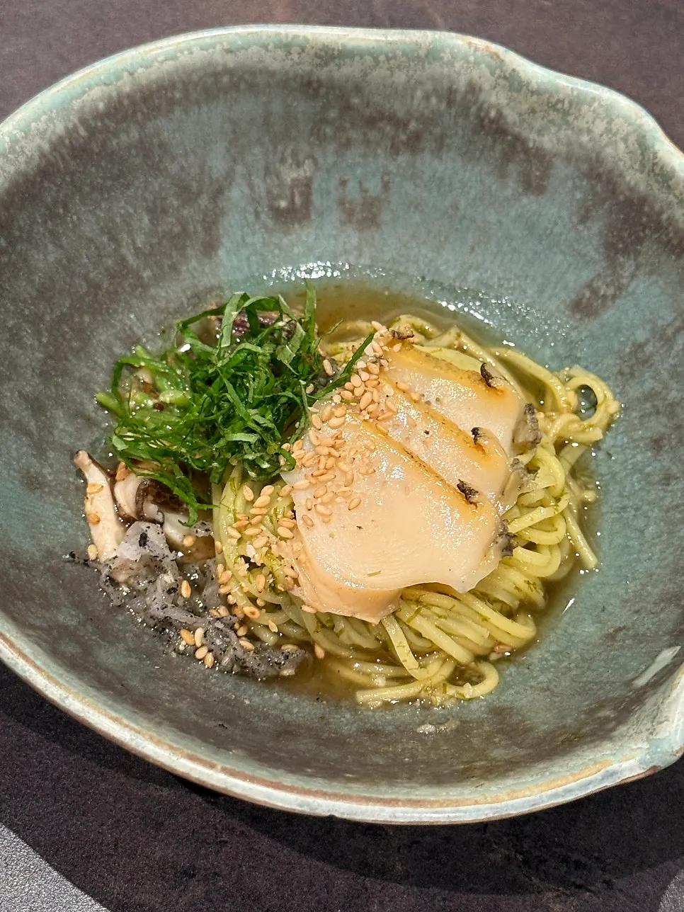 Gardenia noodles topped with black sesame radish and abalone garnish