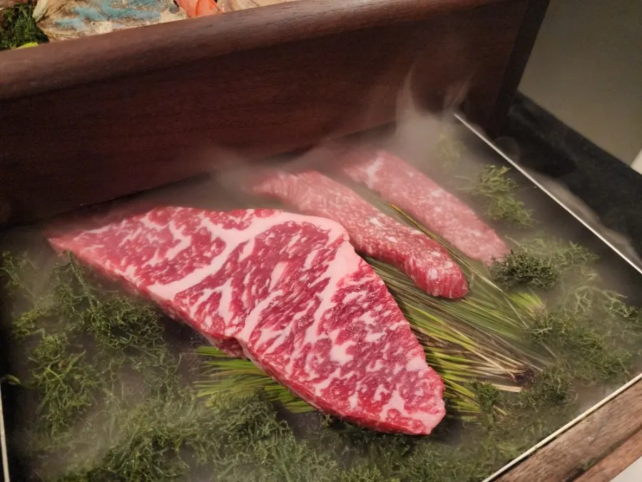 Wooden case holding marbled Hanwoo sirloin