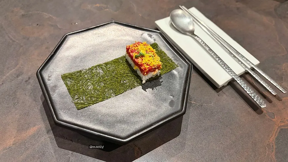 Fourth course of raw beef tartare and gamtae in gimbap form