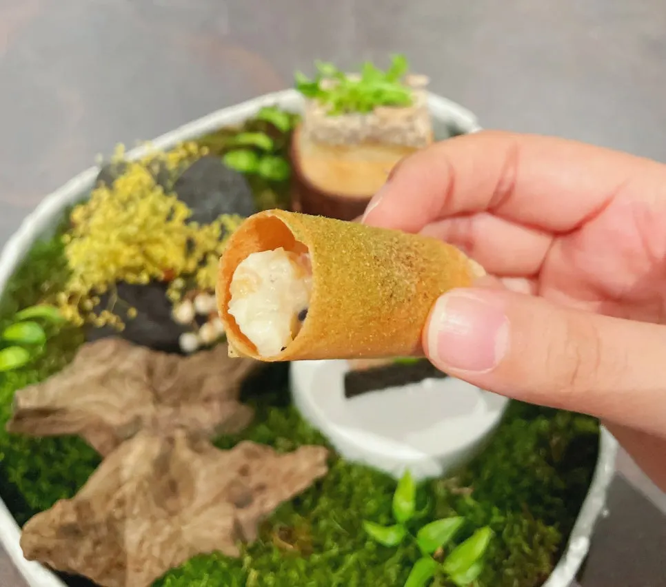 Scallop and clam bite served in brick pastry