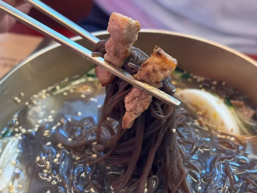 Pork belly served alongside the naengmyeon