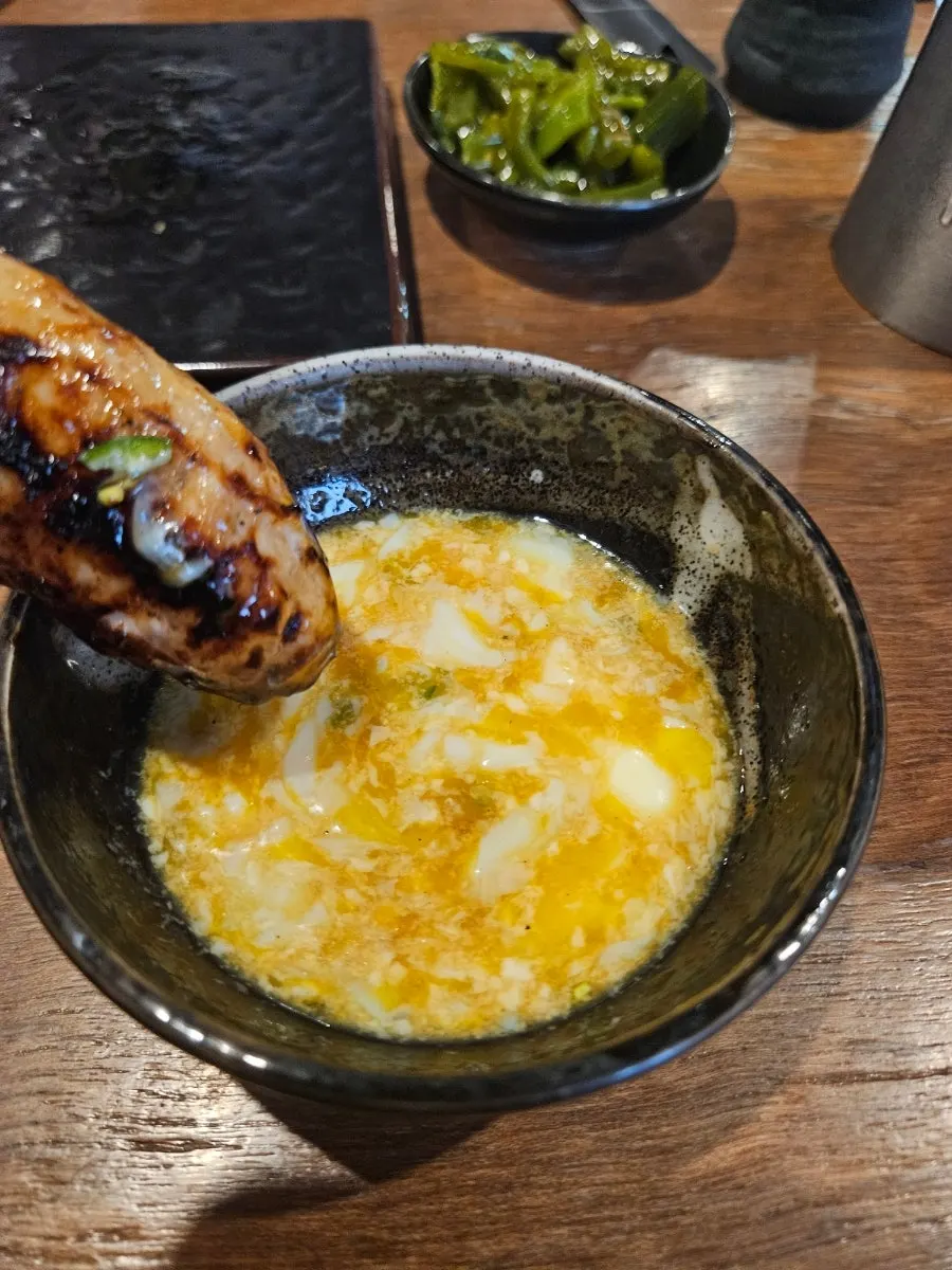 Elongated grilled tsukune skewer