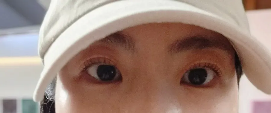 Selfie taken at a café after the treatment showing defined eyes
