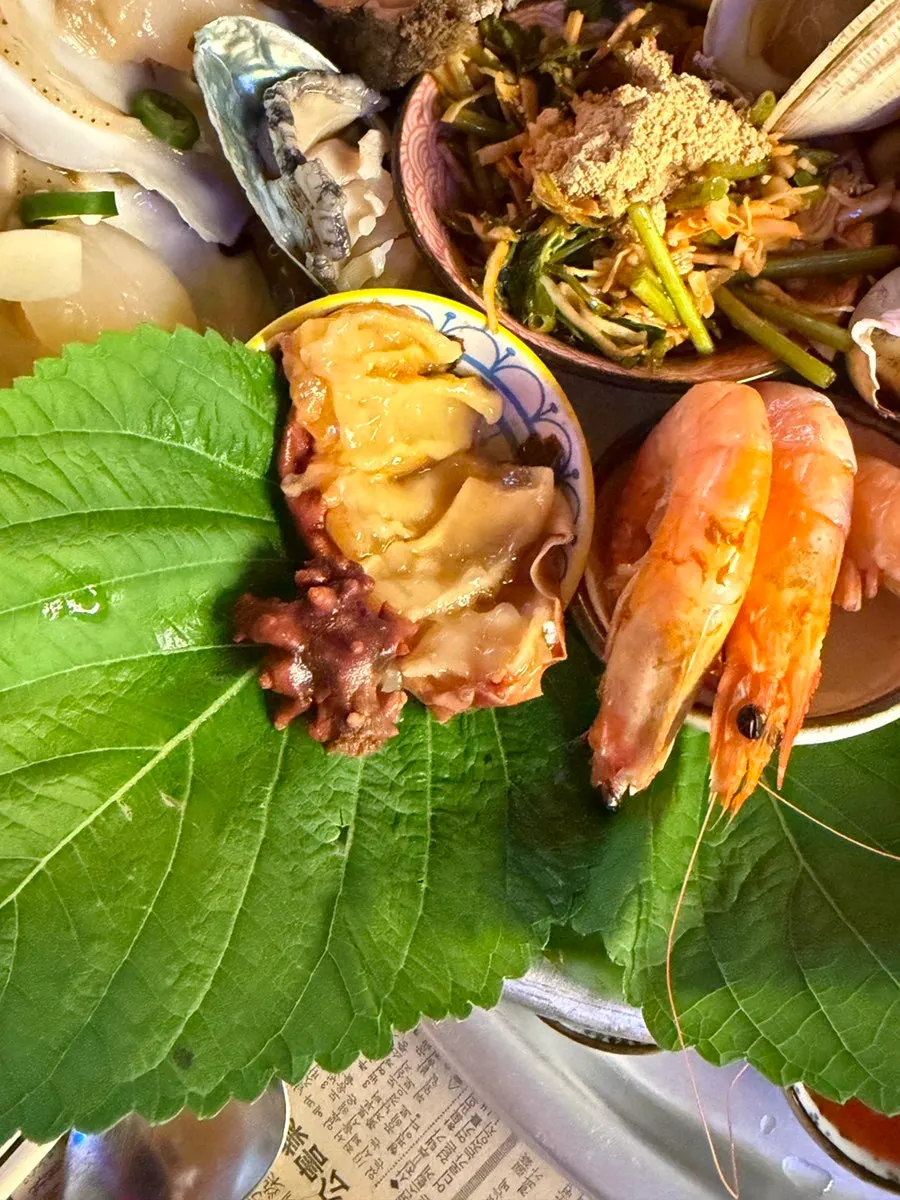 Plate of steamed seafood including shrimp and hard clams