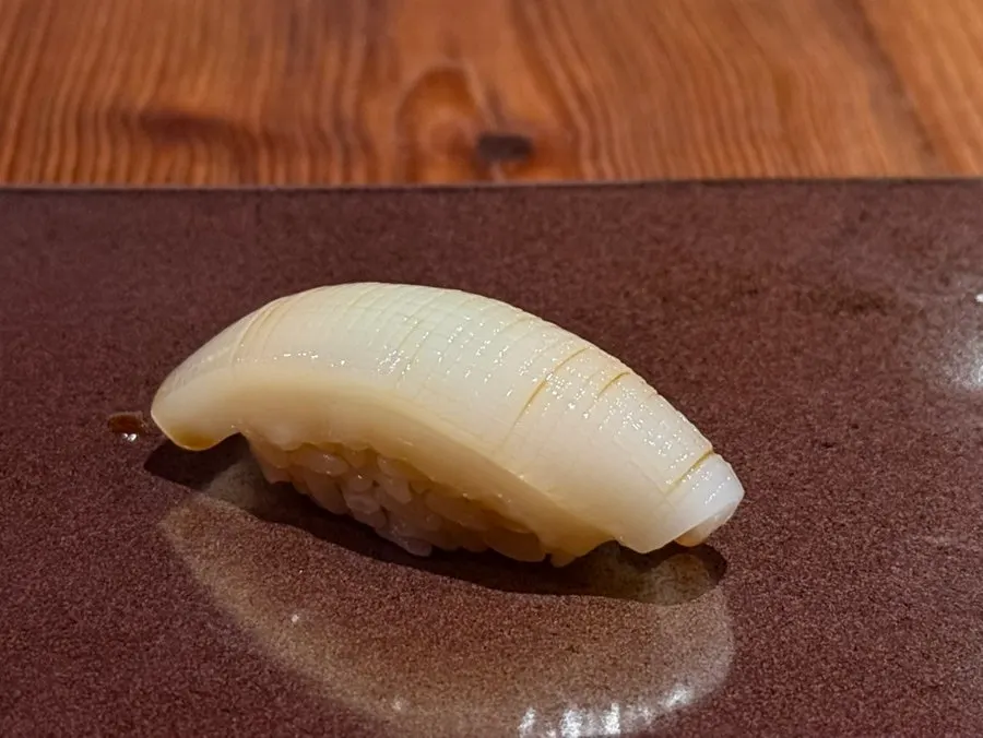Spear squid sushi with tight scoring cuts