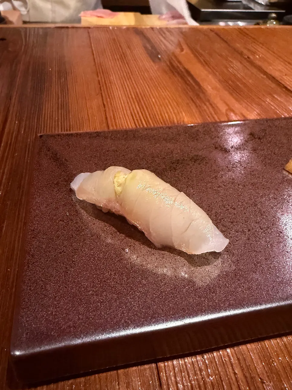 A piece of clean, light white fish sushi