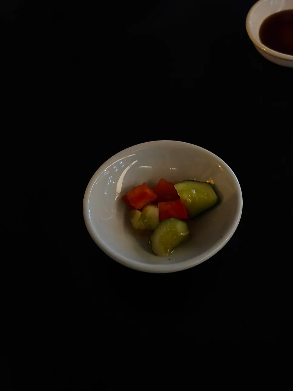 Starter of house-made cucumber and tomato pickles