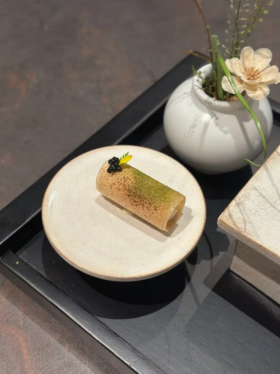 Grilled scallop bite served on brick pastry
