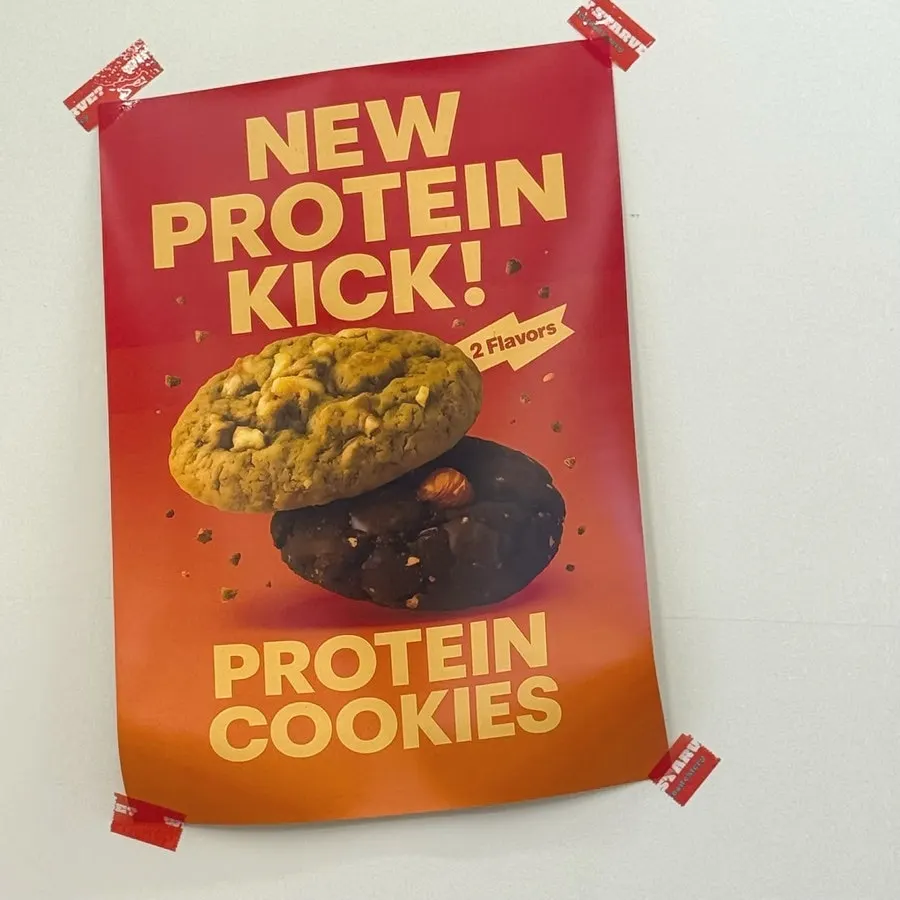 Menu board showing side items like protein cookies