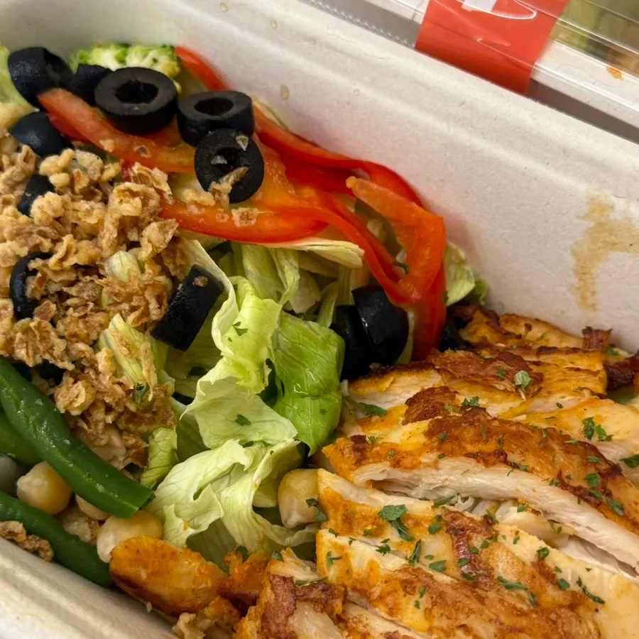 Toppings on the chicken protein box, including lettuce and chickpeas