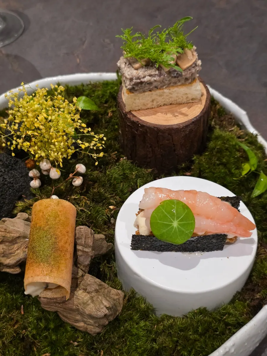 Plating of the amuse-bouche made up of three bite-sized dishes