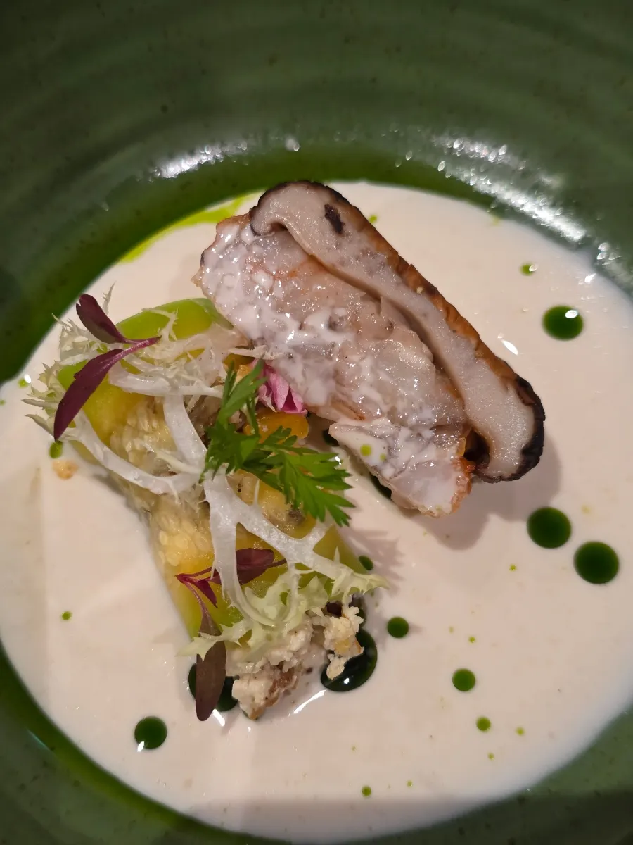 A glass of champagne next to the shiitake and shrimp dish