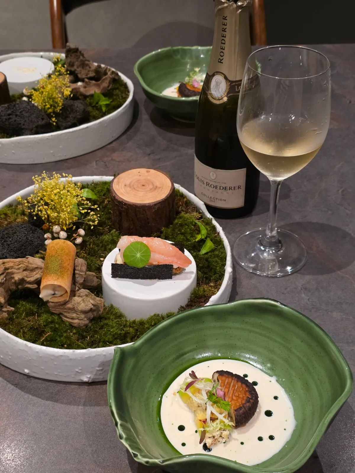 Opened champagne and course dishes on the private room table