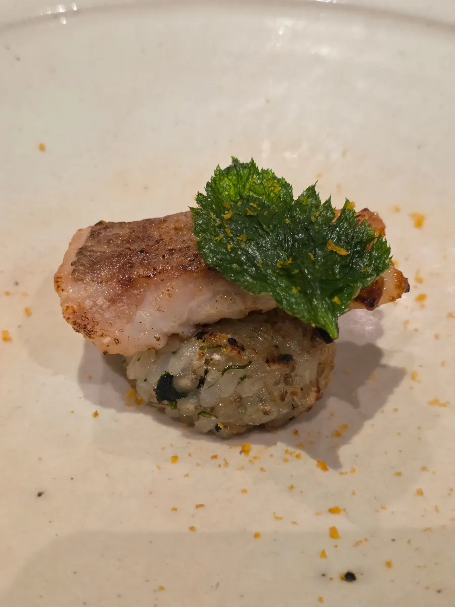 Neungi mushroom broth being poured over the tilefish dish