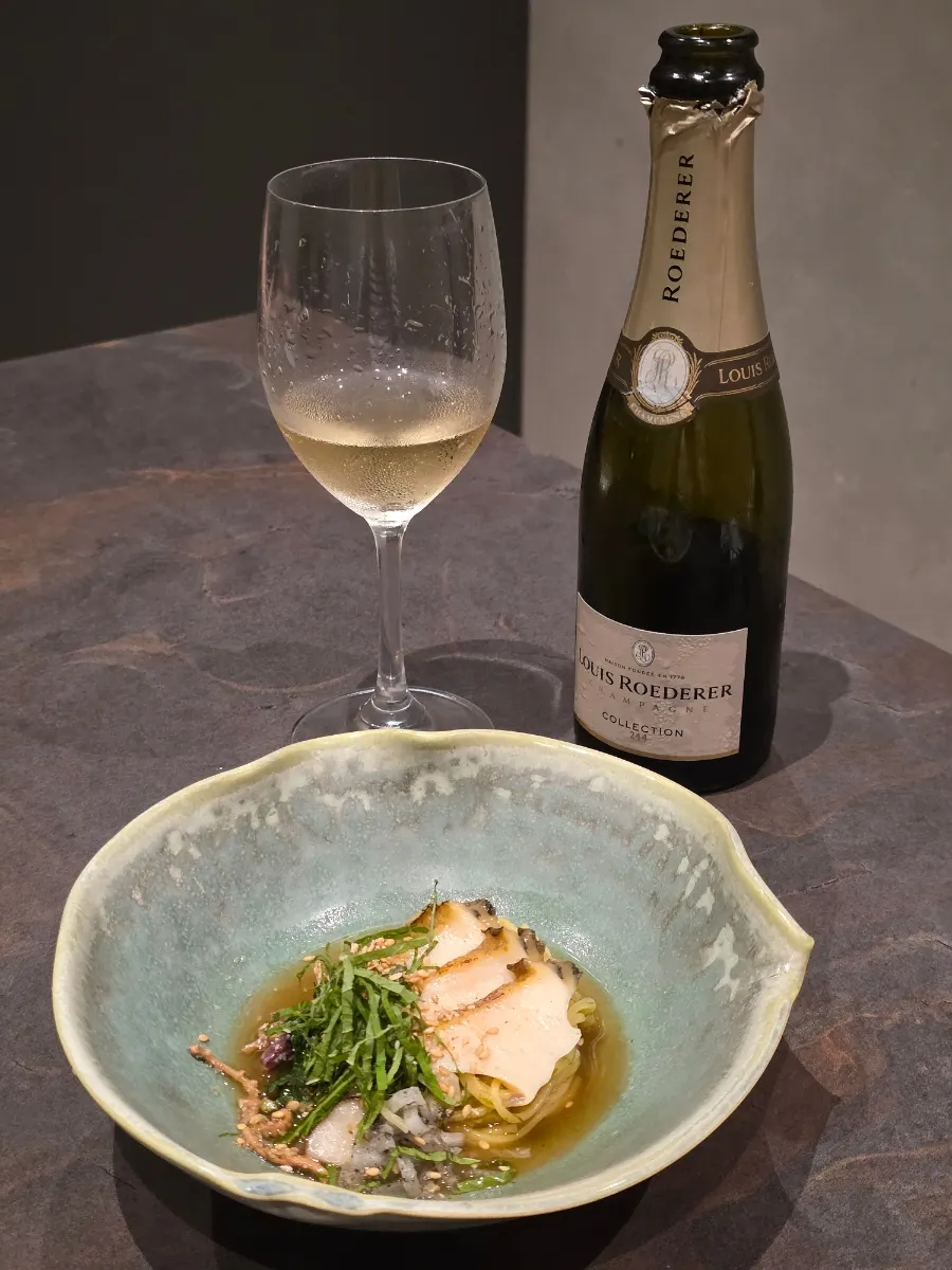 Glass of champagne paired with the gardenia noodles