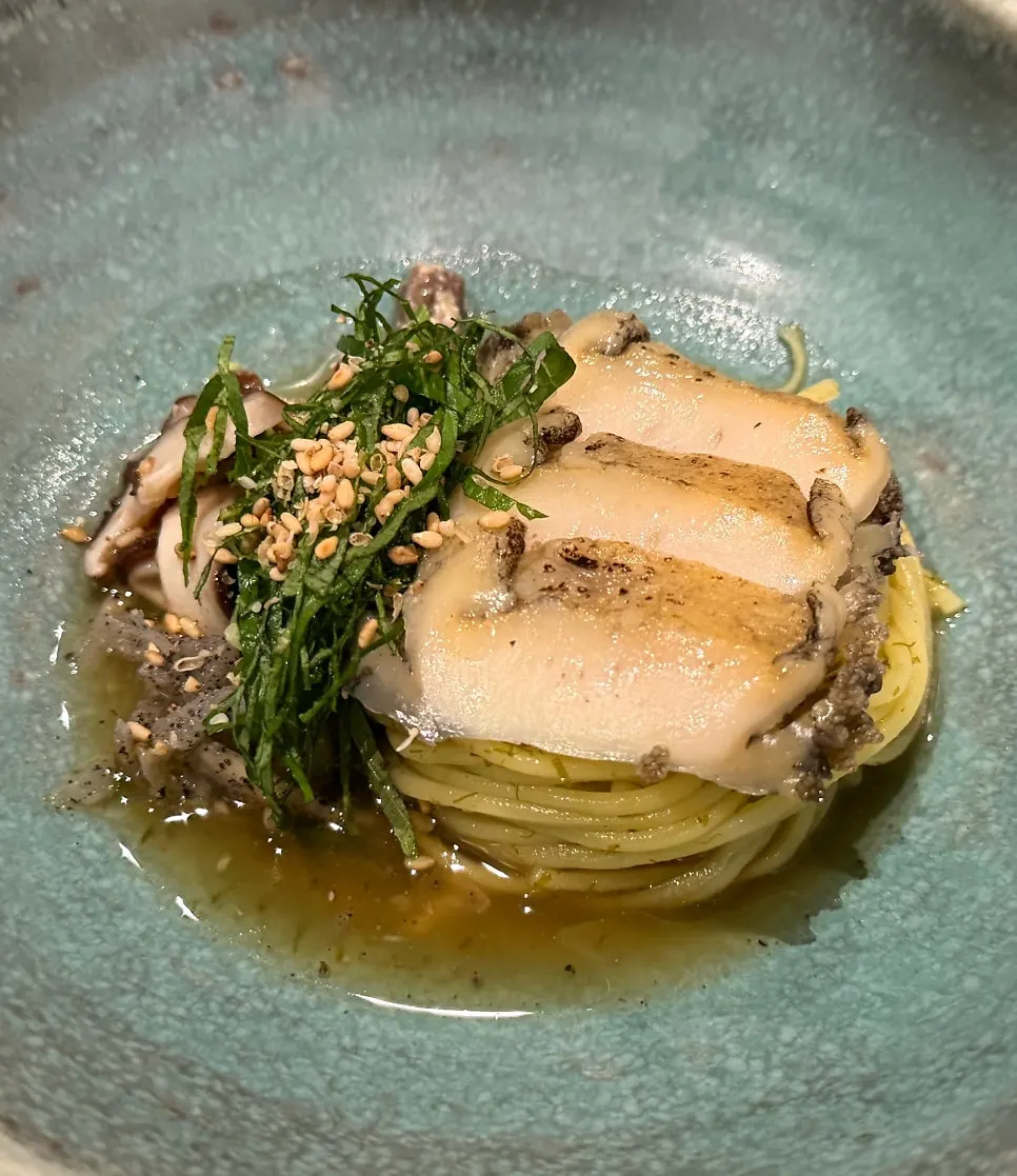 Close-up of abalone gardenia noodles with gamtae dressing